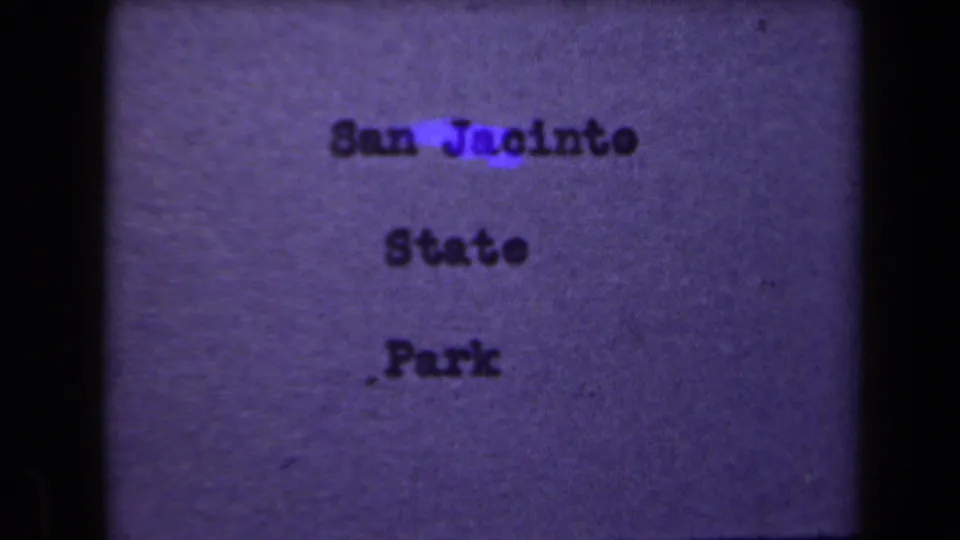 Shifted 8mm title-card frame showing typed San Jacinto State Park text on a purple background with visible frame edge.