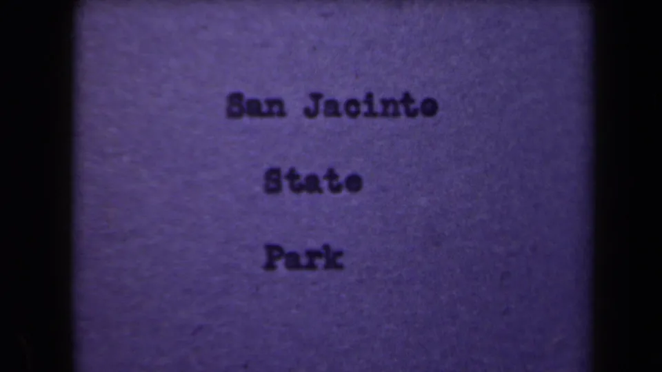 1940s 8mm title card appears to identify San Jacinto State Park, shown with dark film borders and purple color shift.