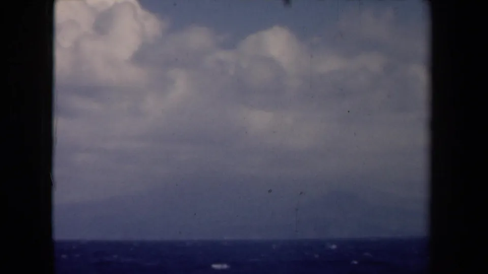 1946 Netherlands 8mm view of puffy clouds above open blue water, with small whitecaps and a low horizon line.
