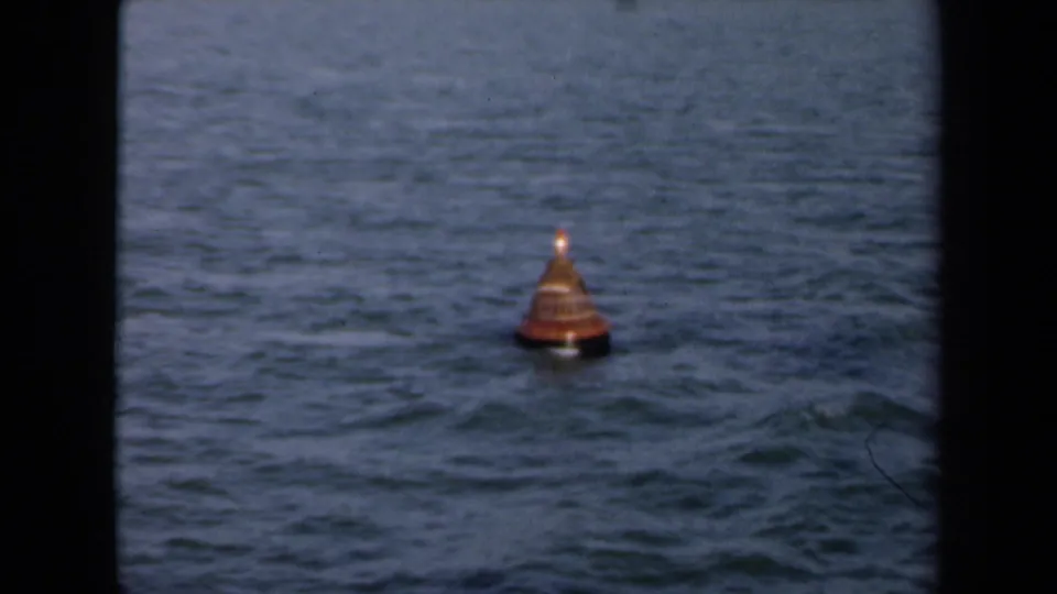 An orange buoy floats in blue-gray water off the Netherlands coast in this 1946 8mm home-movie frame.
