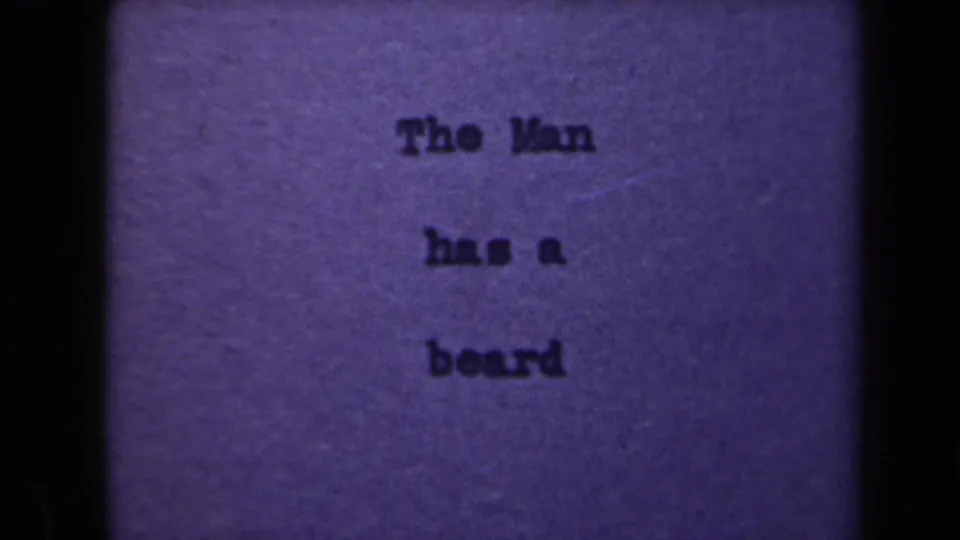 Final visible frame of the short clip holds on the typed card, with purple color shift, soft focus, and small-gauge film texture.