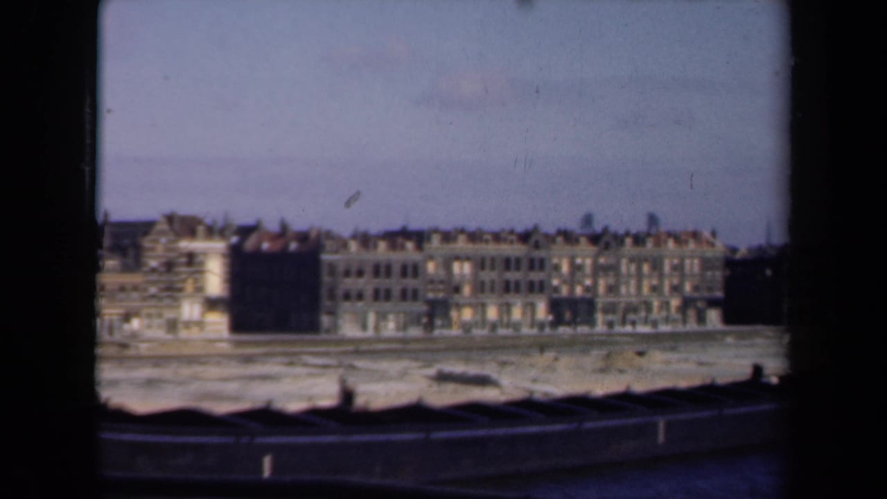 Similar distant view of waterfront facades and a pale open shoreline area.