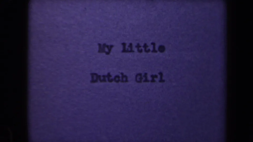 Final sampled 8mm frame showing the My Little Dutch Girl title card, purple color shift, grain, and soft dark edge shadows.