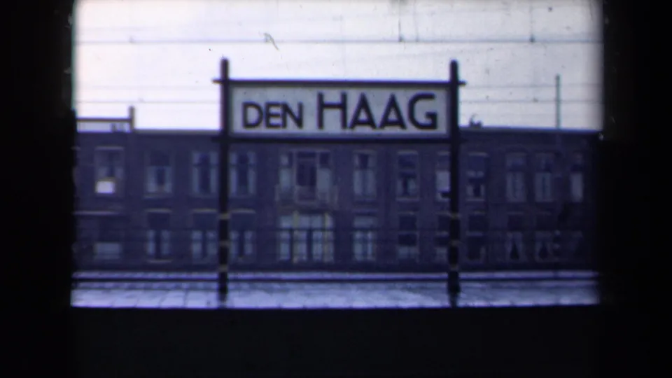 Den Haag station sign remains visible against a brick building in this 1946 Netherlands rail-view frame.