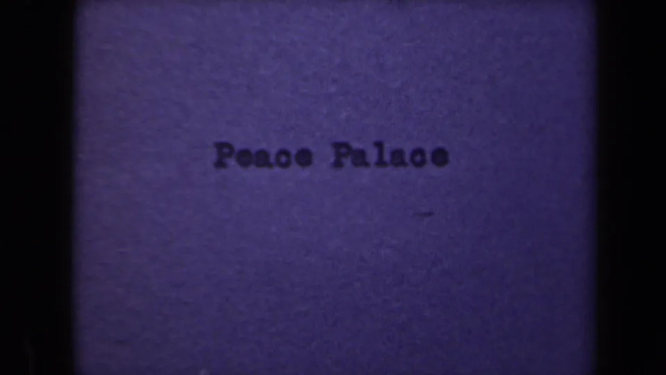 Second Peace Palace title frame from the 1946 8mm clip, with soft focus, muted color, and visible film texture.
