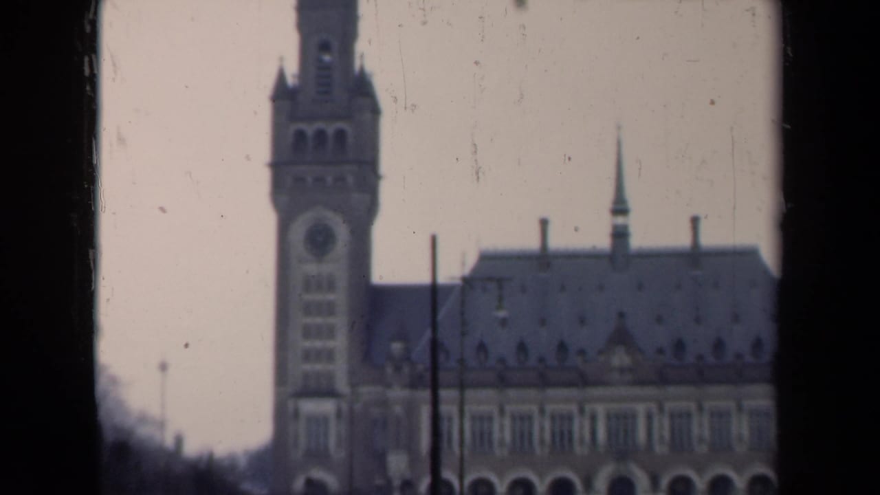 Historic building with clock tower, roofline, and lamp posts in a soft 8mm frame.