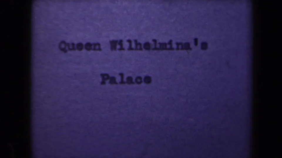 1946 8mm title card with centered typewritten text naming Queen Wilhelmina's Palace against a purple background.