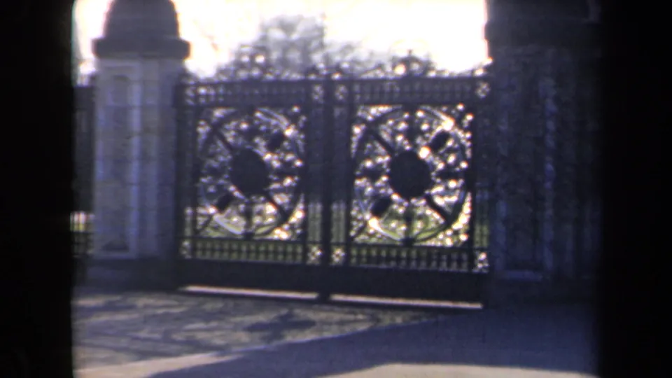 A second gate view shows the wrought-iron entrance, stone supports, and tree shadows in the 1946 Netherlands clip.