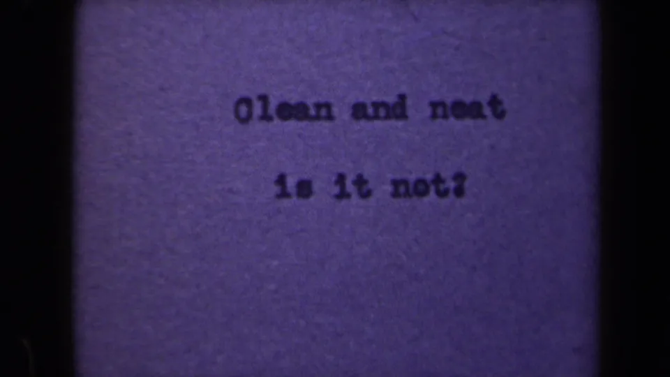 Purple-tinted 8mm frame from 1946 Netherlands with a centered typewritten phrase and visible film grain.
