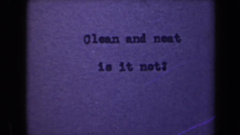 1946 Netherlands 8mm frame with the same typed Clean and neat phrase, softened by grain and uneven exposure.