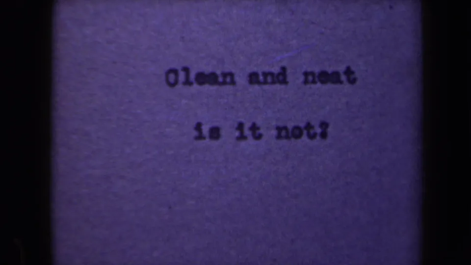 Final 1946 Netherlands 8mm frame showing the typewritten phrase on purple paper with dark gate framing and visible grain.