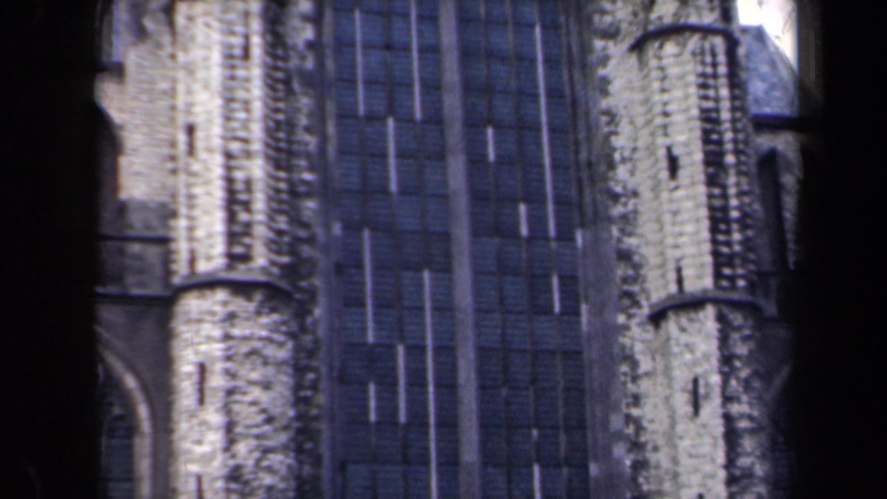 1946 Netherlands 8mm frame with pale stone Gothic-style verticals beside tall dark window panels, seen through a contact-sheet scan.