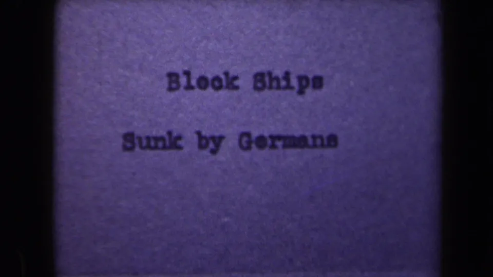 Purple-toned 8mm title card repeats "Block Ships Sunk by Germans," with grain, soft focus, and visible gate borders.