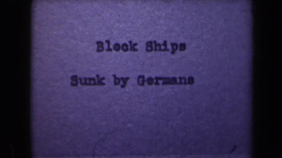 1946 Netherlands 8mm title card with typewritten text reading “Block Ships Sunk by Germans” against a purple-tinted field.