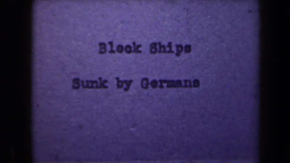Repeated 8mm title frame in purple tint, showing the words “Block Ships Sunk by Germans” centered in the film frame.