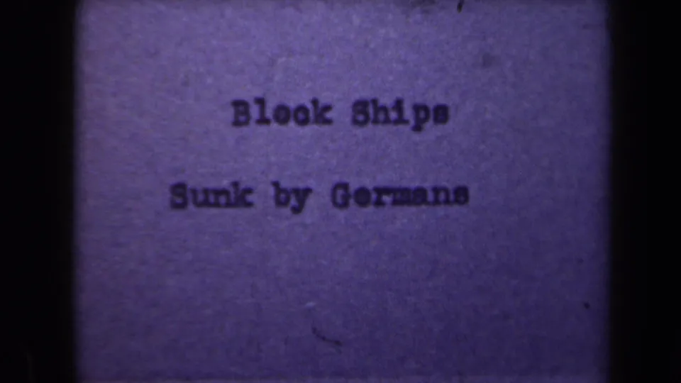 A later title-card frame keeps the same text visible, with heavier grain, dim exposure, and dark gate edges.