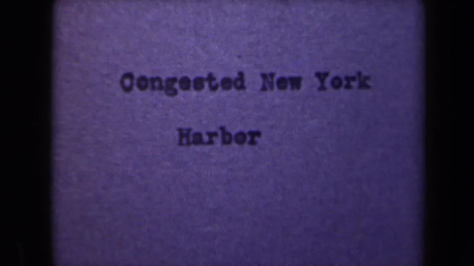 Centered title card on purple stock, reading Congested New York Harbor, with visible grain and uneven 8mm exposure.