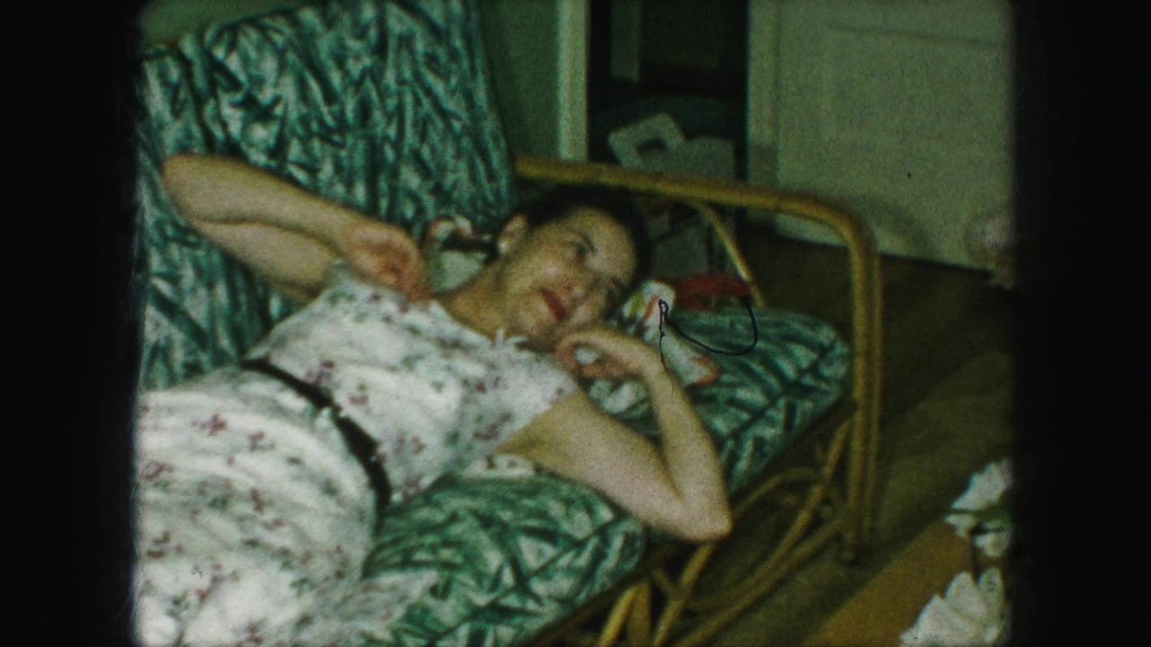 Woman lying on the couch with one hand raised near her face.