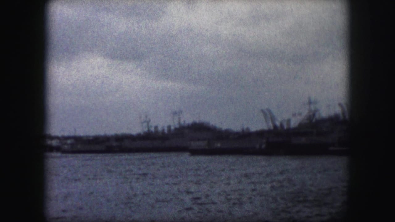 1959 Kansas City metadata-supported harbor view with water, distant vessels, cranes or masts, and dark 8mm frame edges.