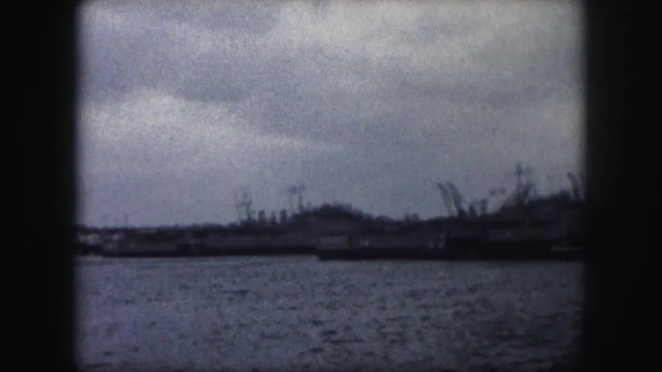 1959 Kansas City metadata-supported harbor view with water, distant vessels, cranes or masts, and dark 8mm frame edges.