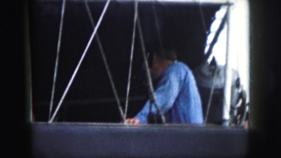 The final 1959 Kansas City frame keeps the man partly obscured by support cables inside the shadowed gondola-like compartment.