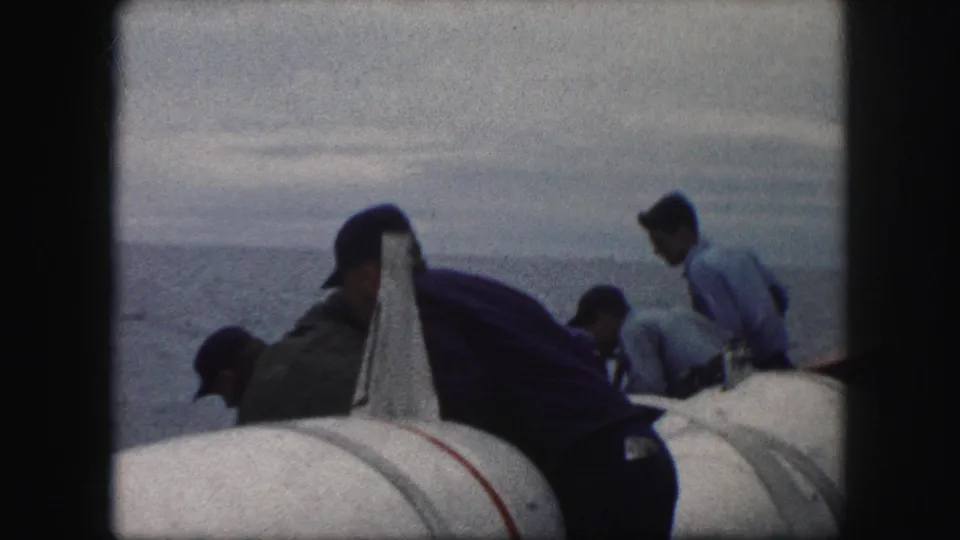 The final frame shows men working or steadying themselves near white flotation gear on the cataloged 1959 vessel.