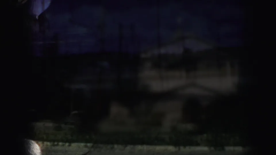 Underexposed 1959 8mm frame from Kansas City with a faint church exterior obscured by dark film or window framing.