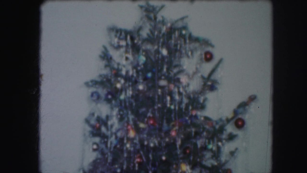 Upper section of the Christmas tree with dense tinsel and ornaments, consistent with the Kansas City 1959 home-movie metadata.