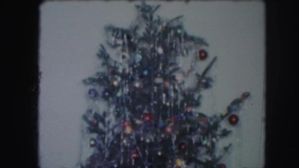Upper section of the Christmas tree with dense tinsel and ornaments, consistent with the Kansas City 1959 home-movie metadata.