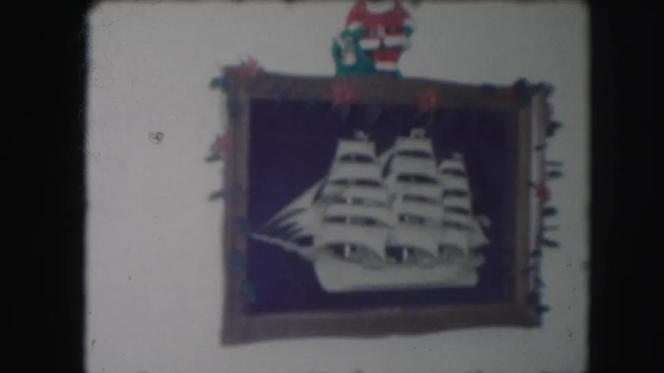 Final 1959 Kansas City frame holding on the white sailing ship cutout, dark blue backing, Santa figure, and small Christmas decorations.