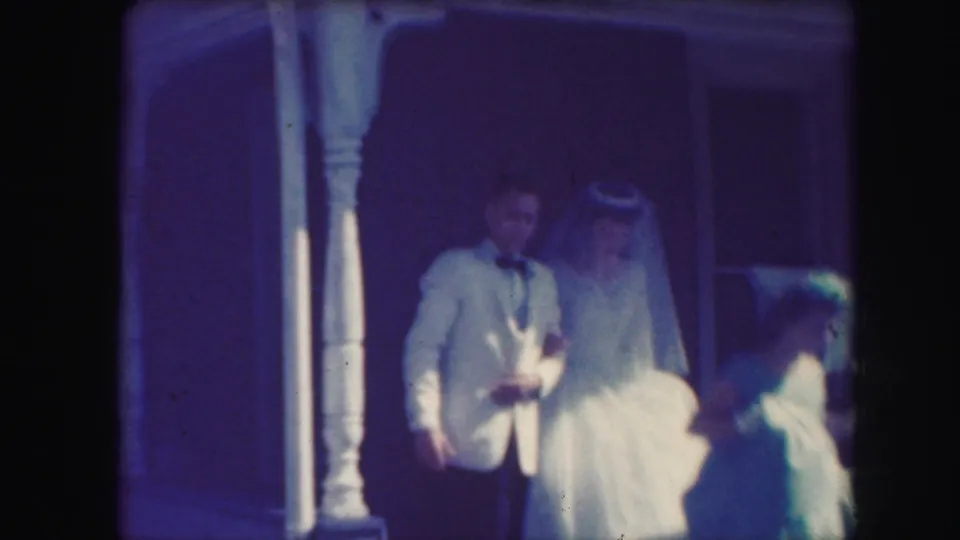 1959 Kansas City wedding frame with groom in a light suit, bride in veil, and a bridesmaid partly visible.