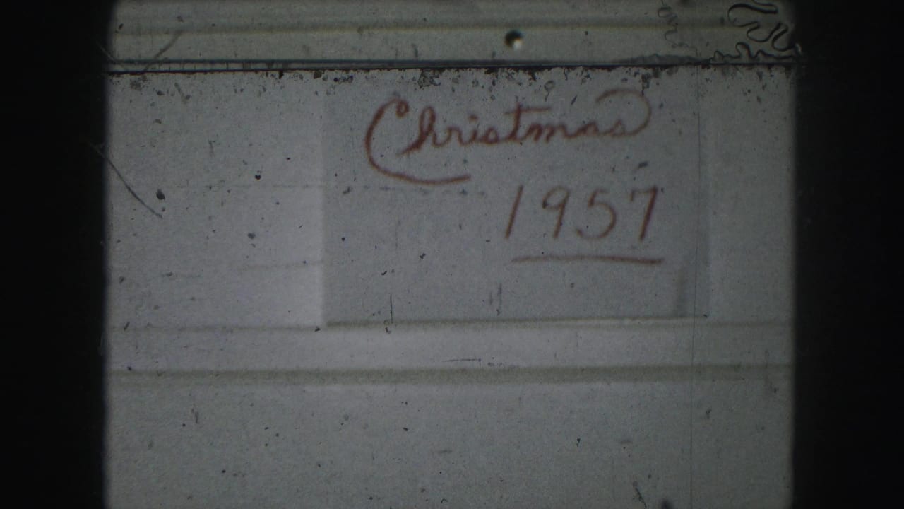 The words “Christmas 1957” appear in red near the upper right of a pale surface.