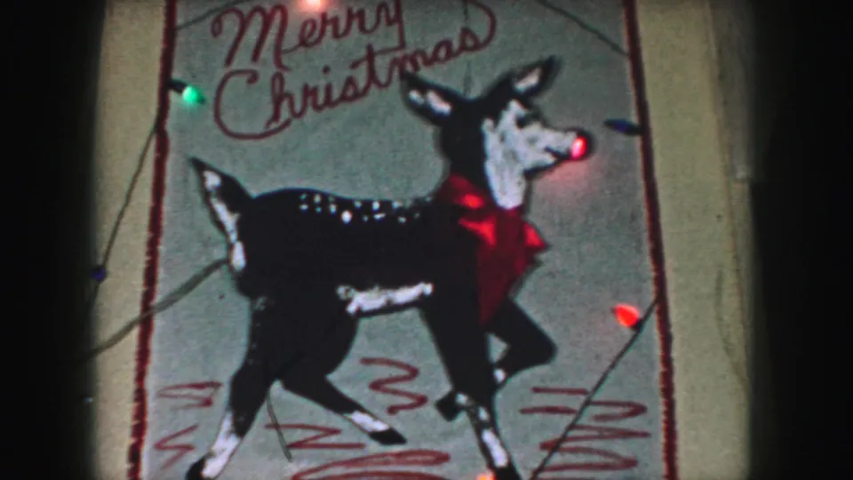 1959 Kansas City frame showing the Christmas reindeer decoration with visible film grain and colored bulbs.