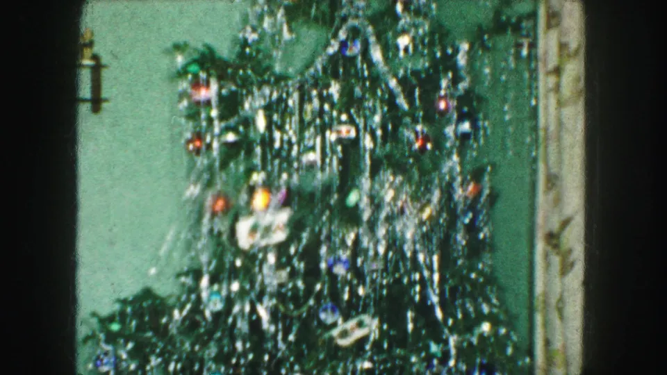 Soft 8mm frame from a 1959 Kansas City home movie showing the decorated Christmas tree during slight camera movement.