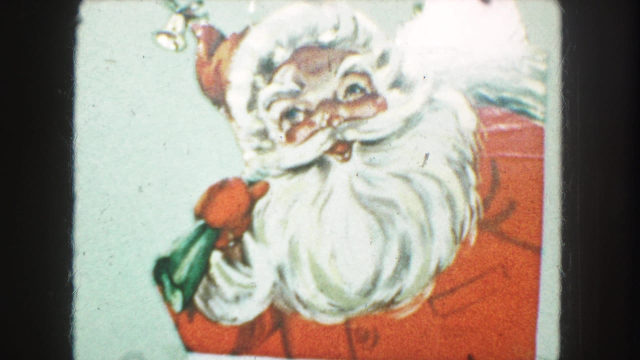 Close 8mm frame of the Kansas City Christmas card, centered on Santa's face, beard, red clothing, and green gift bag.