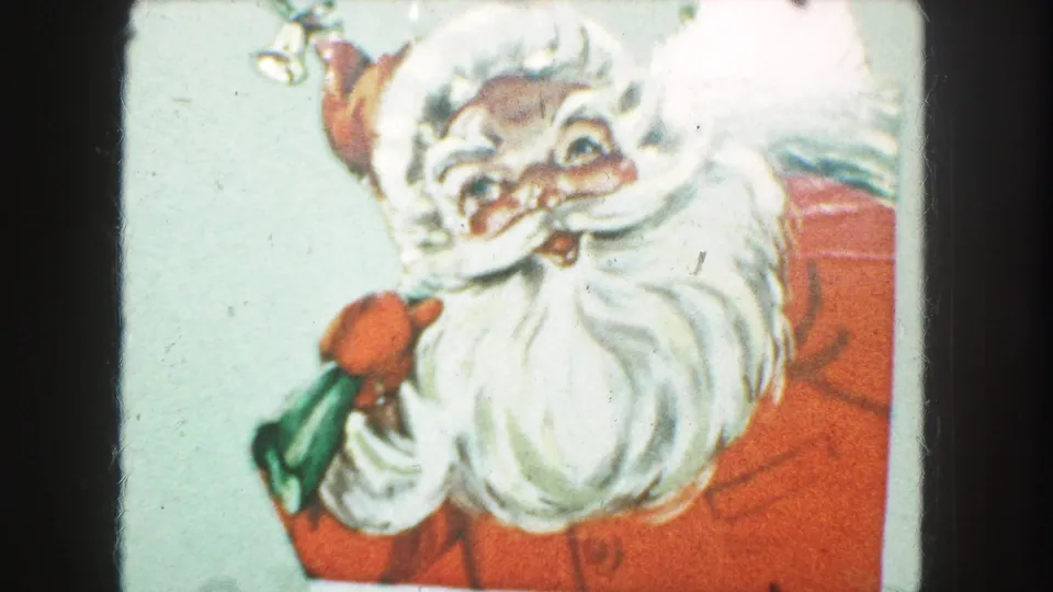 Close 8mm frame of the Kansas City Christmas card, centered on Santa's face, beard, red clothing, and green gift bag.