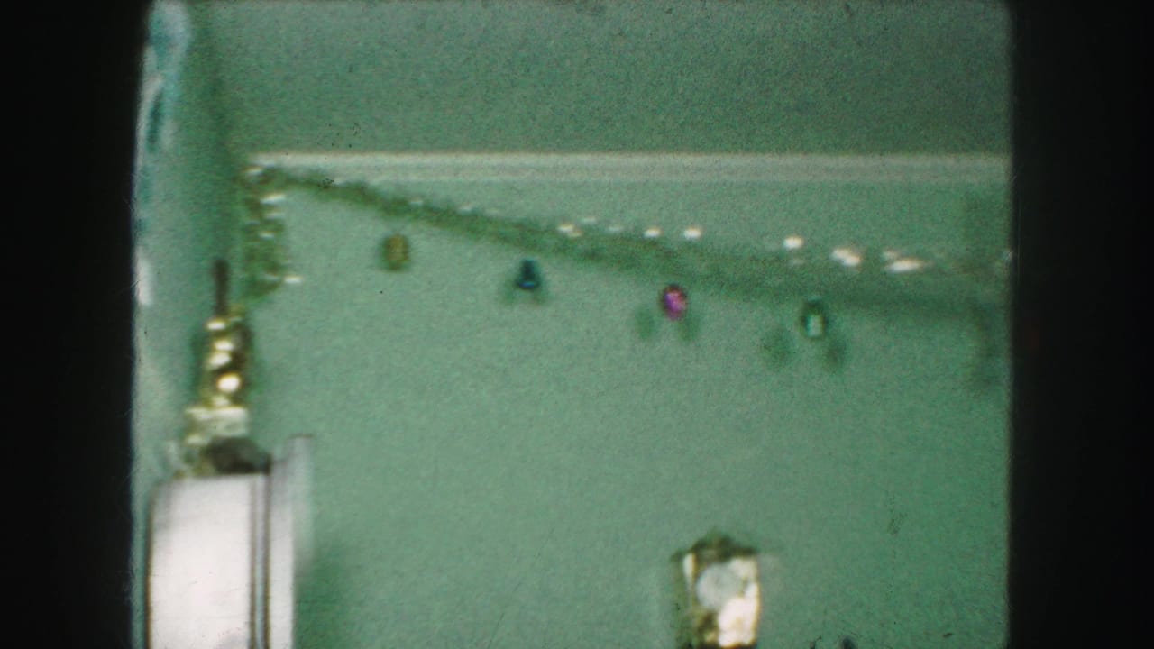 Ceiling garland and small hanging ornaments above a decorated room corner.