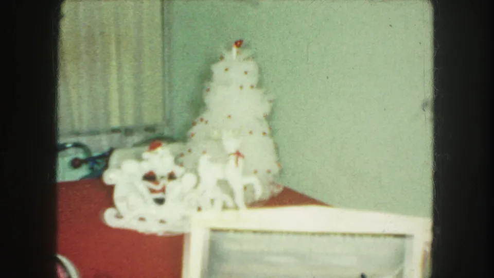 Kansas City 1959 8mm frame showing the holiday display partly obscured by a foreground handwritten sign.