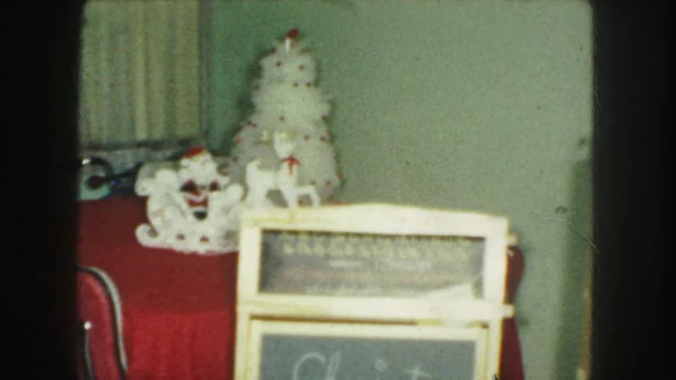 1959 Kansas City holiday frame with white Santa and tree decorations behind a foreground Christmas sign.