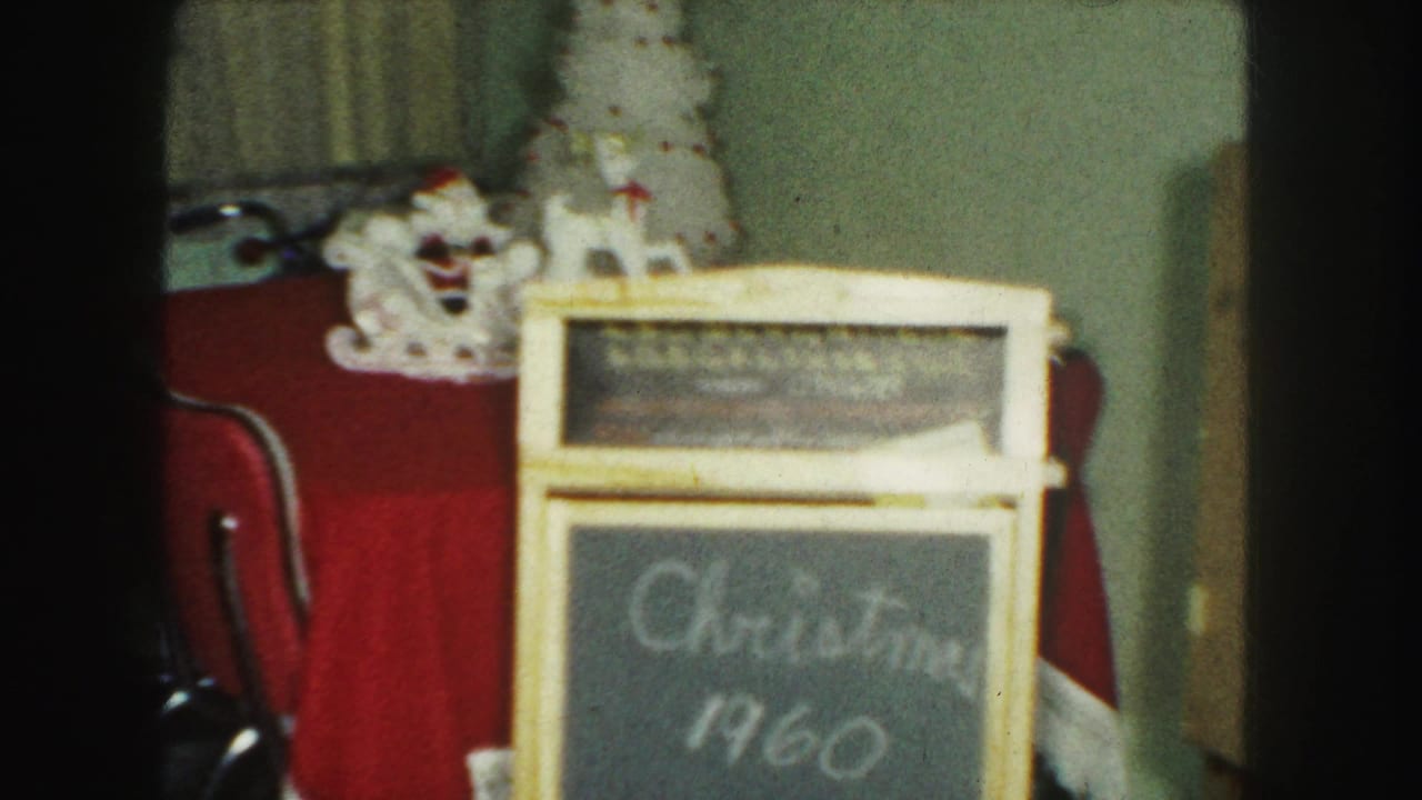 Red-covered table with ceramic Santa, small white tree, and chalkboard reading Christmas 1959.