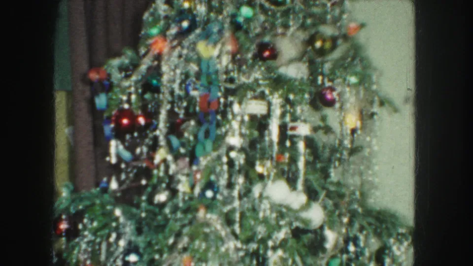 1959 Kansas City frame with a fuller view of the indoor Christmas tree, covered in silver tinsel, colored ornaments, and small lights.