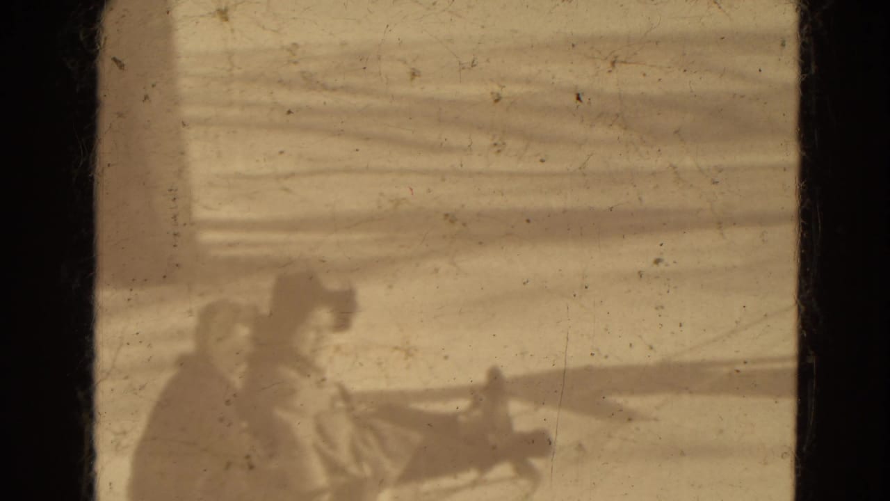 Horse and sleigh pass through the snowy frame with bundled riders aboard.