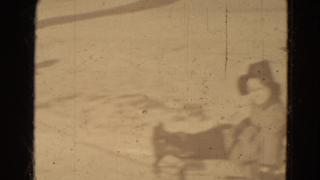 A distant bundled person appears seated on a sled in snowy Lincoln, Nebraska home-movie footage from 1942.
