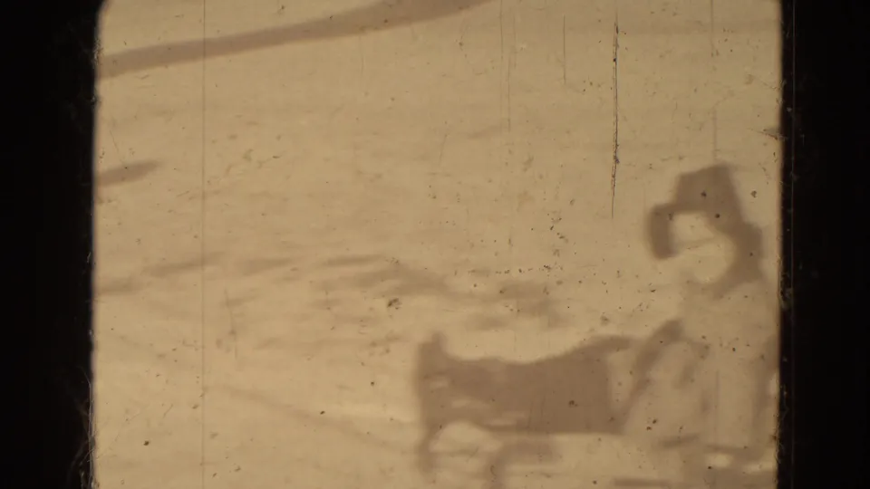A distant bundled person appears seated on a sled in snowy Lincoln, Nebraska home-movie footage from 1942.