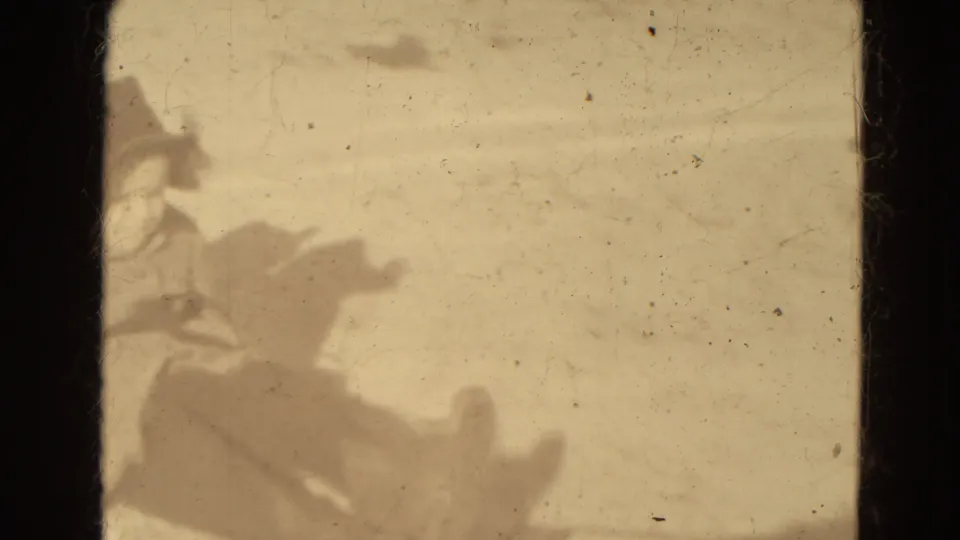 Blurred distant figures and sled forms appear in snowy Lincoln, Nebraska home-movie footage from 1942.