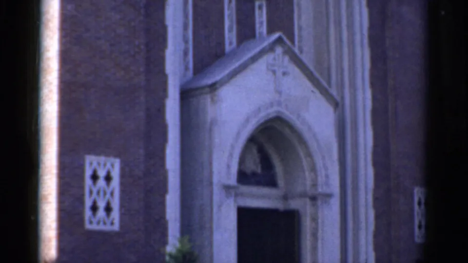 1975 Bridgeport church exterior showing the lower facade, arched entrance, small patterned window, and brick-and-stone detailing.