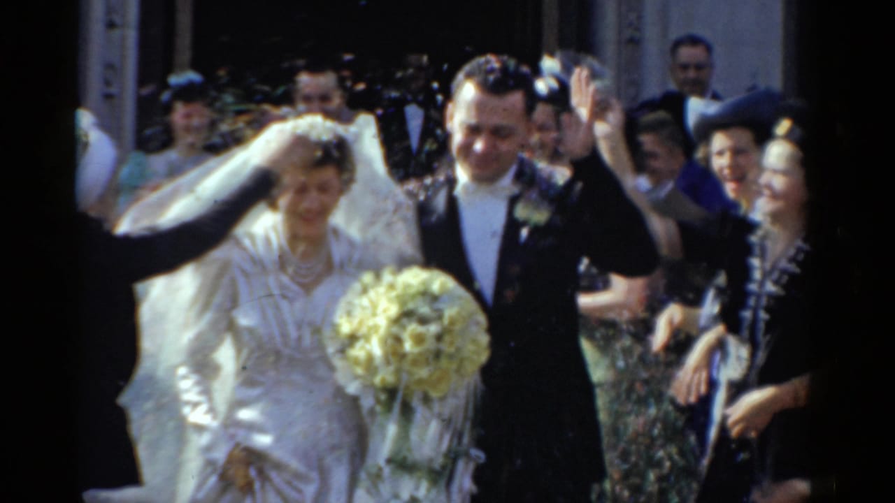 1975 Bridgeport wedding couple steps from a church doorway as guests toss confetti and the bride carries a pale bouquet.
