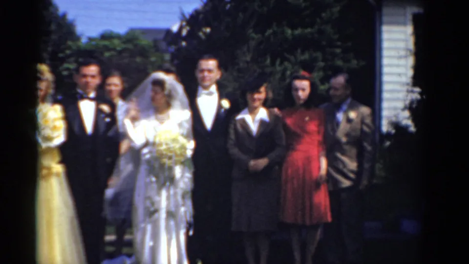 A wider 1975 Bridgeport wedding-party view shows the bride, groom, and attendants posed outdoors in bright sunlight.