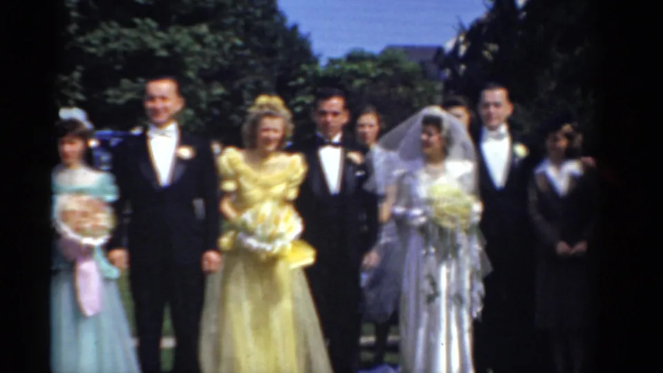 A 1975 outdoor wedding group in Bridgeport includes the bride, groom, bridesmaids, groomsmen, and a young attendant standing on a lawn.