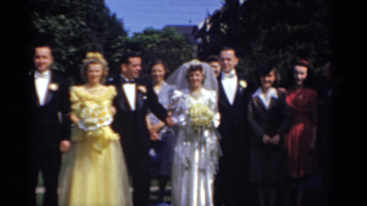 Bridgeport, Connecticut 1975 wedding party posing outdoors, with the bride in a white gown and veil beside the groom and guests.